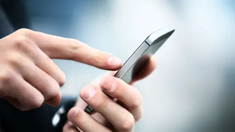 34198353 - close up of a man using mobile smart phone